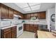 Functional kitchen featuring wood cabinets, white appliances, and ample counter space at 13902 E Marina Dr # 303, Aurora, CO 80014