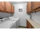 Convenient laundry room features a washer, dryer and plenty of storage space in the wood cabinets at 13902 E Marina Dr # 303, Aurora, CO 80014