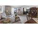 Cozy living room featuring floral sofas, vintage furnishings, and natural light from the sliding door at 13902 E Marina Dr # 303, Aurora, CO 80014