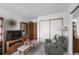 Relaxing living area with a recliner, TV, and storage, creating a comfortable atmosphere at 13902 E Marina Dr # 303, Aurora, CO 80014