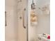 This shower features white tiling, safety bars, and built in storage at 13902 E Marina Dr # 303, Aurora, CO 80014