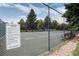 Neighborhood tennis court surrounded by mature trees at 13902 E Marina Dr # 303, Aurora, CO 80014