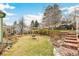 Well-maintained backyard featuring a play swing, lush lawn, landscaping, and backyard shed at 7681 S Jellison St, Littleton, CO 80127