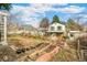 Beautiful backyard and partial exterior view of home with a garden and lots of green space at 7681 S Jellison St, Littleton, CO 80127