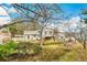 Beautiful backyard and partial exterior view of home with green grass, garden, and shed at 7681 S Jellison St, Littleton, CO 80127