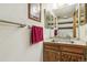 Bathroom featuring a vanity with a stainless steel sink and wood cabinet at 7681 S Jellison St, Littleton, CO 80127