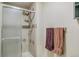 Bathroom featuring tiled shower with glass door and adjacent towel rack at 7681 S Jellison St, Littleton, CO 80127