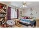 Charming bedroom with cozy chair, stuffed animals, and a castle-themed wall painting at 7681 S Jellison St, Littleton, CO 80127