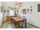 Cozy dining room with a classic chandelier, neutral wall color, and a window for natural light at 7681 S Jellison St, Littleton, CO 80127