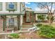 Charming front entrance with brick accents, green trim, and a welcoming doorway and landscaped front yard at 7681 S Jellison St, Littleton, CO 80127