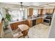 Sunlit eat-in kitchen with wood cabinets, and stainless steel appliances at 7681 S Jellison St, Littleton, CO 80127