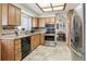Traditional kitchen featuring oak cabinets, tile backsplash, and stainless steel appliances at 7681 S Jellison St, Littleton, CO 80127