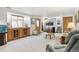 Spacious living room featuring built in cabinets, natural light and direct kitchen access at 7681 S Jellison St, Littleton, CO 80127