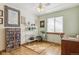 Bright office space featuring hardwood floors, white shelving, and a ceiling fan at 7681 S Jellison St, Littleton, CO 80127