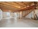 Spacious unfinished basement with concrete floor and exposed wood ceiling, ready for customization and personalization at 20888 E 51St Pl, Denver, CO 80249