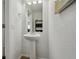 Small bathroom with a pedestal sink and mirror at 20888 E 51St Pl, Denver, CO 80249