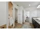 Bathroom featuring a walk-in shower, a vanity with double sinks, and neutral colored tile at 20888 E 51St Pl, Denver, CO 80249