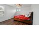 Bedroom featuring a medium-sized bed, a window, and wood floor at 20888 E 51St Pl, Denver, CO 80249