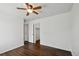 Bedroom featuring dark wood floor, a ceiling fan, and a closet at 20888 E 51St Pl, Denver, CO 80249