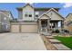 Charming two-story home with a three-car garage and stone-accented facade at 20888 E 51St Pl, Denver, CO 80249
