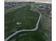 Aerial view of a golf course winding through a residential area, perfect for golf enthusiasts at 16218 E 111Th Pl, Commerce City, CO 80022