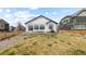 Spacious backyard with grass, gravel area, and patio seating at 16218 E 111Th Pl, Commerce City, CO 80022