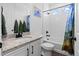 Modern bathroom featuring a shower over tub, granite vanity, and stylish fixtures at 16218 E 111Th Pl, Commerce City, CO 80022