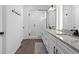 Elegant bathroom featuring dual sinks, granite counters, modern fixtures, and a glass-enclosed shower at 16218 E 111Th Pl, Commerce City, CO 80022