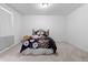 Bright bedroom with carpeted floors, a window with curtains, and a patterned comforter at 16218 E 111Th Pl, Commerce City, CO 80022