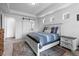 Charming bedroom features a tray ceiling, carpet, and a sliding barn door to the Primary bathroom at 16218 E 111Th Pl, Commerce City, CO 80022