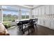 Cozy dining area with a rustic table set with large windows overlooking green space at 16218 E 111Th Pl, Commerce City, CO 80022