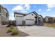 Attractive single Gathering home with stone accents, a three car garage and a well-maintained lawn at 16218 E 111Th Pl, Commerce City, CO 80022