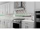 Modern kitchen showcases stainless steel appliances, custom backsplash, and granite countertops at 16218 E 111Th Pl, Commerce City, CO 80022