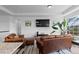Relaxing living room with hardwood floors, a large TV, and comfortable leather seating at 16218 E 111Th Pl, Commerce City, CO 80022