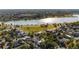 Aerial view showcasing a lake with city views in a desirable location with mature trees at 2034 Newton St, Denver, CO 80211