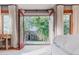 Bedroom balcony with view of backyard, featuring trees, black railings, and open doors at 2034 Newton St, Denver, CO 80211