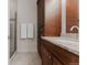 Bathroom vanity with granite countertop, dark wood cabinets, and a separate glass-enclosed shower at 2034 Newton St, Denver, CO 80211