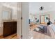 Bright bathroom with a vanity, leading to an office space with an exercise bike at 2034 Newton St, Denver, CO 80211