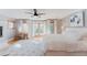 Spacious bedroom with fireplace, balcony access, wood floors, and a large bed at 2034 Newton St, Denver, CO 80211