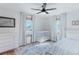 Bright bedroom featuring a crib, ceiling fan, and natural light through the windows at 2034 Newton St, Denver, CO 80211