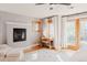 Stylish bedroom with a fireplace, hardwood floors, desk and chair, plus a balcony access at 2034 Newton St, Denver, CO 80211
