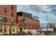 Edgewater building showing architectural details, a rooftop terrace, and commercial space available for rent at 2034 Newton St, Denver, CO 80211