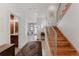 Bright entryway featuring light hardwood floors, stairs with metal railing, and an elegant area rug at 2034 Newton St, Denver, CO 80211