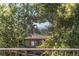 Charming home exterior framed by lush trees offering a glimpse of mountain views at 2034 Newton St, Denver, CO 80211