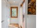 Hallway with hardwood floors, natural light from the window, and access to rooms at 2034 Newton St, Denver, CO 80211