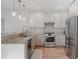 Bright kitchen with stainless appliances, granite counters, tile backsplash, and wood floors at 2034 Newton St, Denver, CO 80211