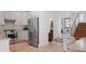 Modern kitchen featuring stainless steel appliances, granite countertops and access to stairs at 2034 Newton St, Denver, CO 80211