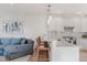 Modern kitchen featuring stainless steel appliances, breakfast bar, and granite countertops at 2034 Newton St, Denver, CO 80211