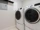 Clean laundry room with modern, front-loading washer and dryer units at 2034 Newton St, Denver, CO 80211