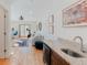 Modern living room and office space featuring a kitchenette with granite countertops at 2034 Newton St, Denver, CO 80211